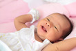infant sleep on the bed and smiling