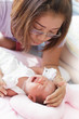 women and infant crying on the  baby bed