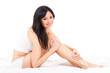 Cute woman sitting on the white bed