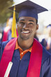 Smiling graduate holding diploma