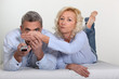 Woman covering her husband's eyes