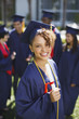 Smiling graduate holding diploma
