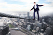 Business man balancing on the rope