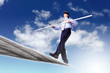 Business man balancing on the rope