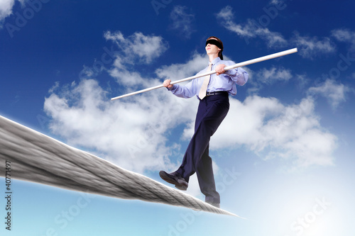 Photo: Business man balancing on the rope Business man balancing on the rope