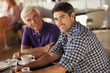 Men drinking coffee together in cafe