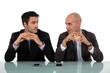 duo of businessmen eating hamburger