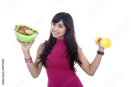 Photo: Woman with fitness food and dumbbell Woman with fitness food and dumbbell