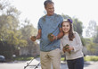 Father and daughter mowing lawn together