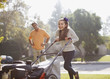 Father and daughter mowing lawn together