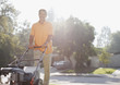Older man mowing front lawn