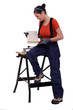 Worker measuring a tile
