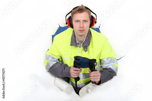 Photo: Worker wearing reflective jacket and drill Worker wearing reflective jacket and drill