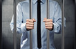 Young corrupted businessman behind the prison bars