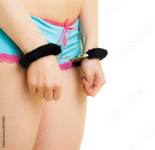 Photo: Girl in panties and handcuffs isolated on white Girl in panties and handcuffs isolated on white
