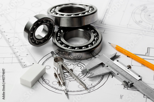 Photo: construction drafts and tools on the table construction drafts and tools on the table