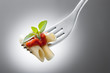 fork with macaroni and tomato