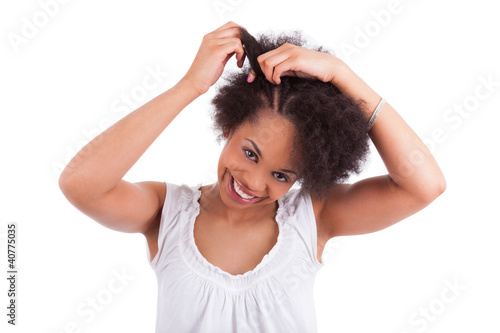 Photo: Young african american woman making braids Young african american woman making braids