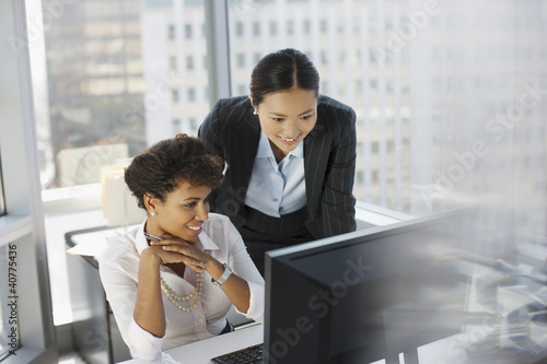 Photo: Businesswomen working together in office Businesswomen working together in office