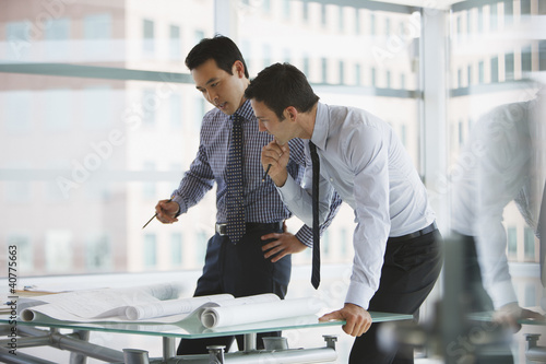 Photo: Businessmen working together in office Businessmen working together in office