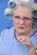 Angry woman with her hair in rollers