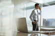 Businessman talking on cell phone in office