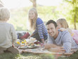 Family picnicking together on grass