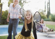 Girl in fairy wings pulling grandfather along