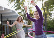 Mother and daughter hula hooping