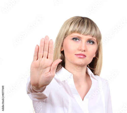 Photo: Young woman making stop gesture isolated on white Young woman making stop gesture isolated on white