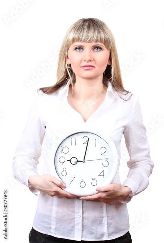 Photo: Young business woman holding clock isolated on white Young business woman holding clock isolated on white