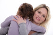 mother embracing her little girl