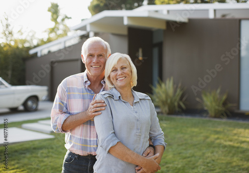Photo: Smiling older couple standing outdoors Smiling older couple standing outdoors