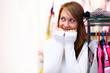 Young woman inside a store buying clothes