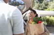 Woman unloading groceries from car