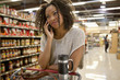 Woman talking on cell phone in supermarket