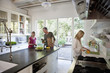 Family unpacking groceries in kitchen