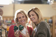 Women examining supplement bottles in store
