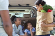 Family unloading groceries from car