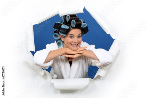 Photo: young woman with curlers in her hair posing young woman with curlers in her hair posing