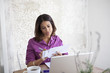 Woman paying bills at table