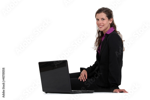 Photo: Businesswoman sitting on the floor with her laptop Businesswoman sitting on the floor with her laptop