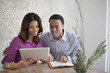 Couple reading from Bible and tablet