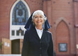Smiling nun walking outdoors