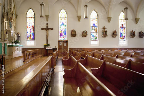 Photo: Pews and stained glass windows in church Pews and stained glass windows in church