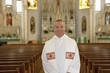 Priest standing in ornate church