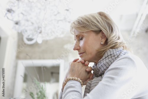 Photo: Older woman clasping hands in prayer Older woman clasping hands in prayer
