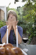 Woman covering her face at Sabbath dinner