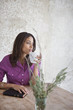 Woman having cup of coffee at table