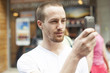 Men on street photographing with mobile phone Men on street photographing with mobile phone